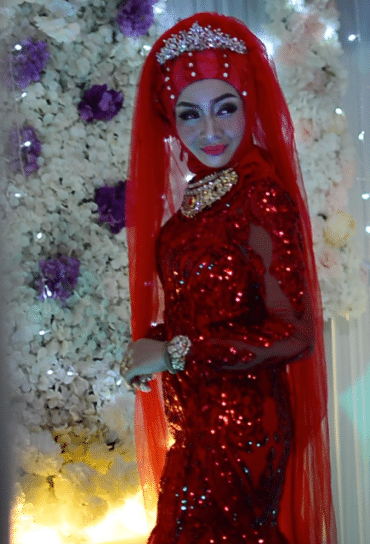 woman in red gown and tiara